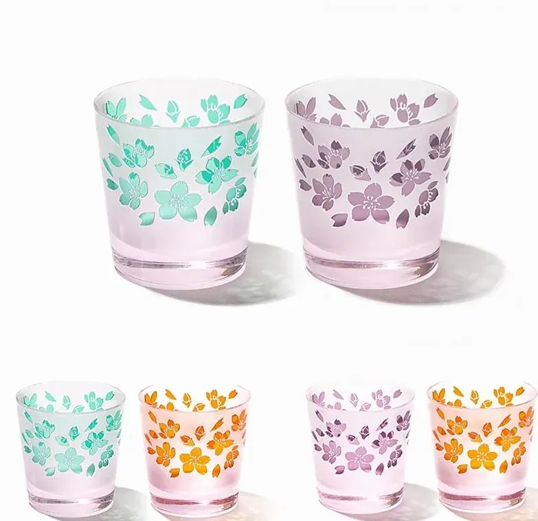 Two pairs of frosted pink cups with carved cherry blossoms in green, orange and violet
