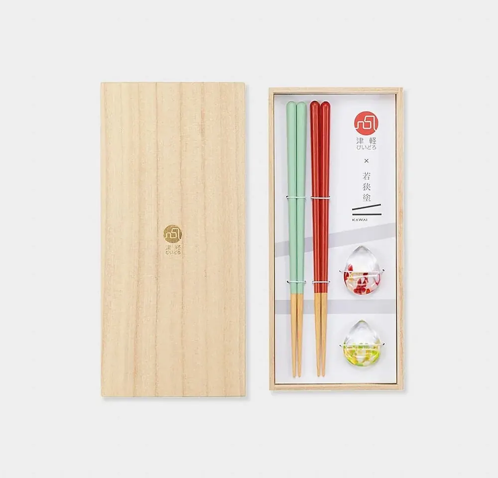 Wooden gift box with two pairs of chopsticks and glass chopstick rests